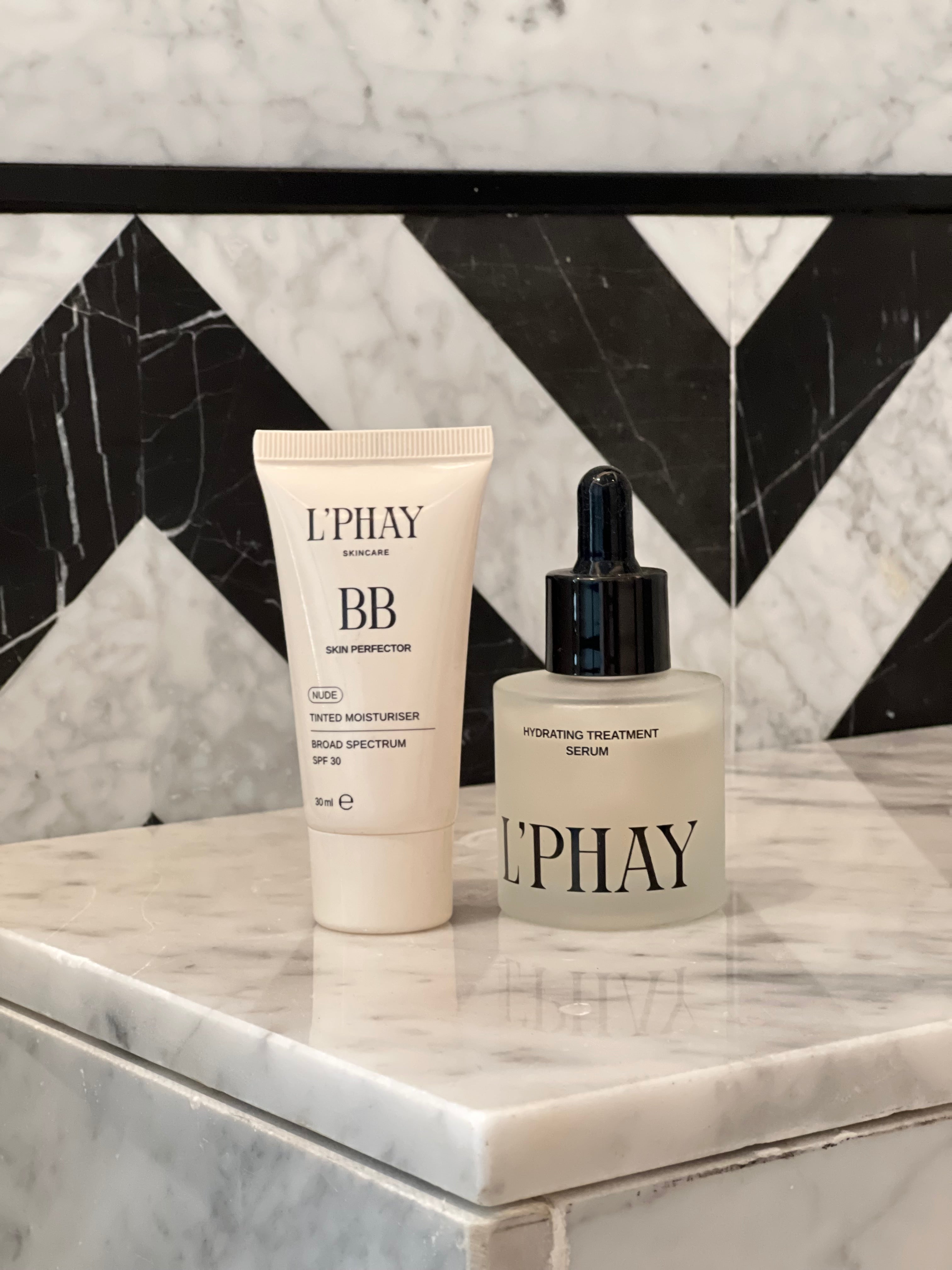 Two products on a marble surface with a black and white geometric pattern.